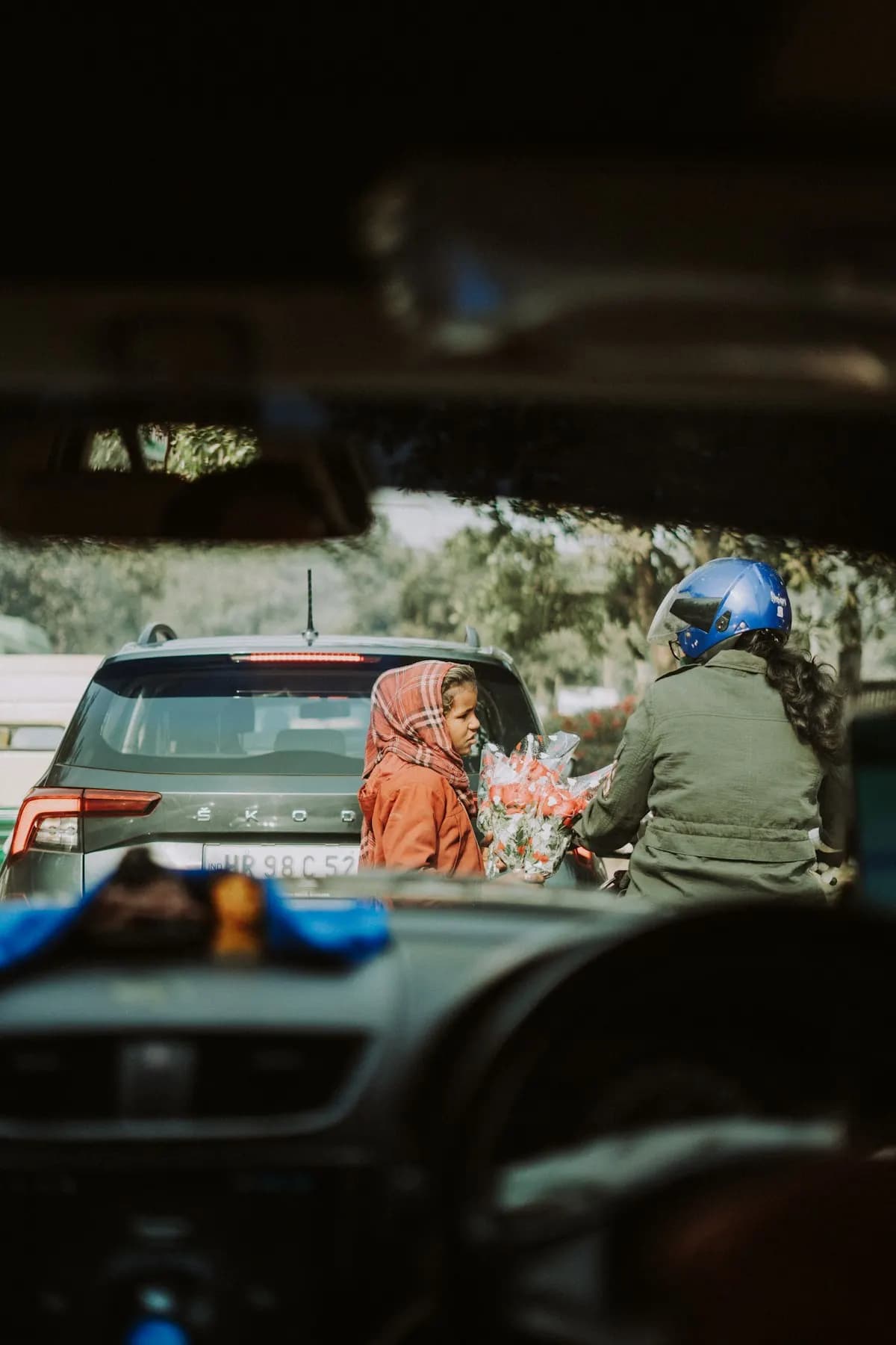 A woman driving with a child in the back seat