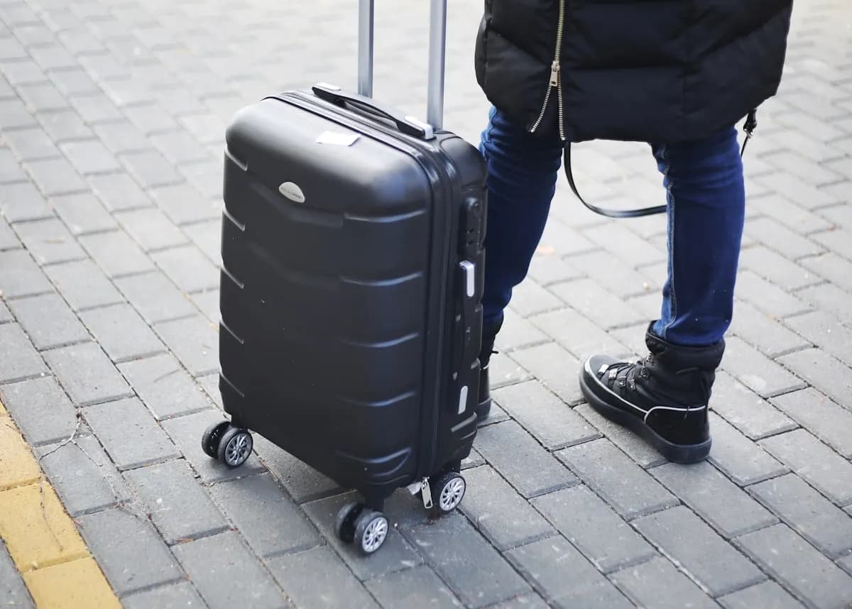 A traveller pulling a suitcase