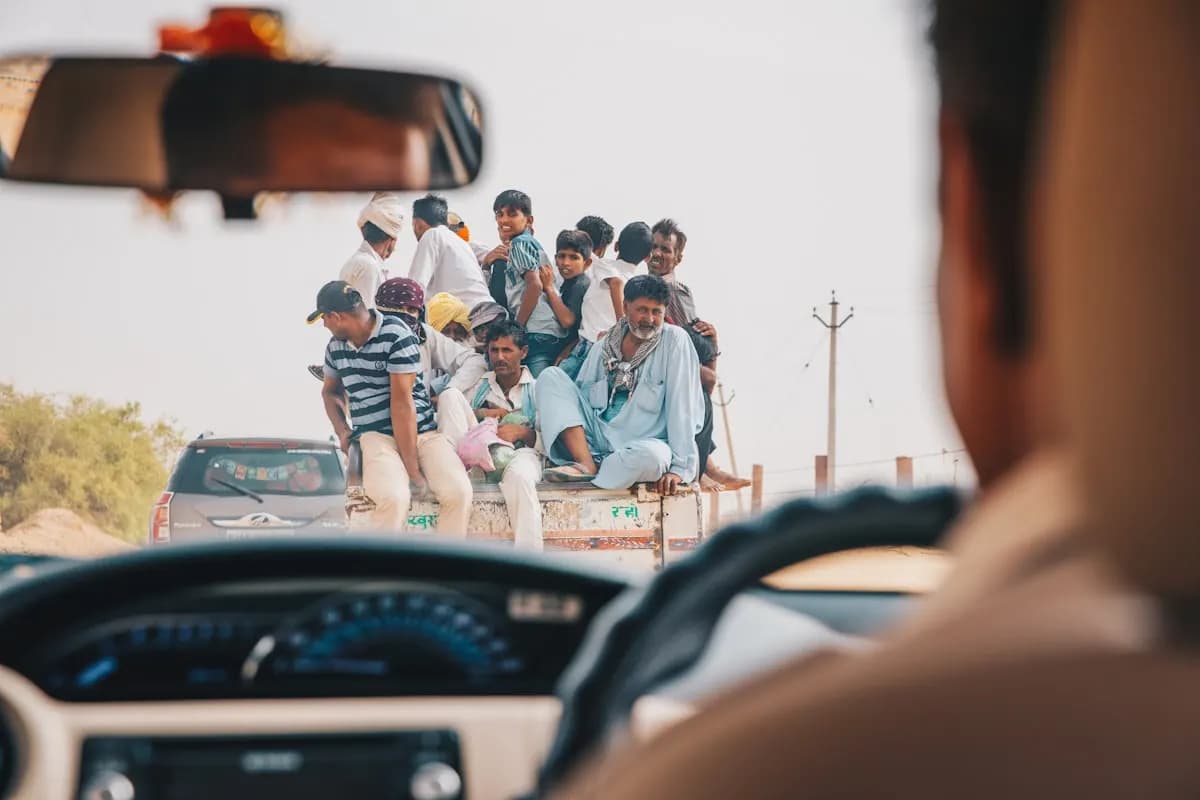 People standing beside a car during the day